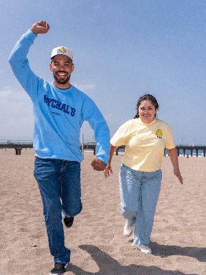 Dante & Elsie Running on the beach in Mychal's Made with Love clothing line